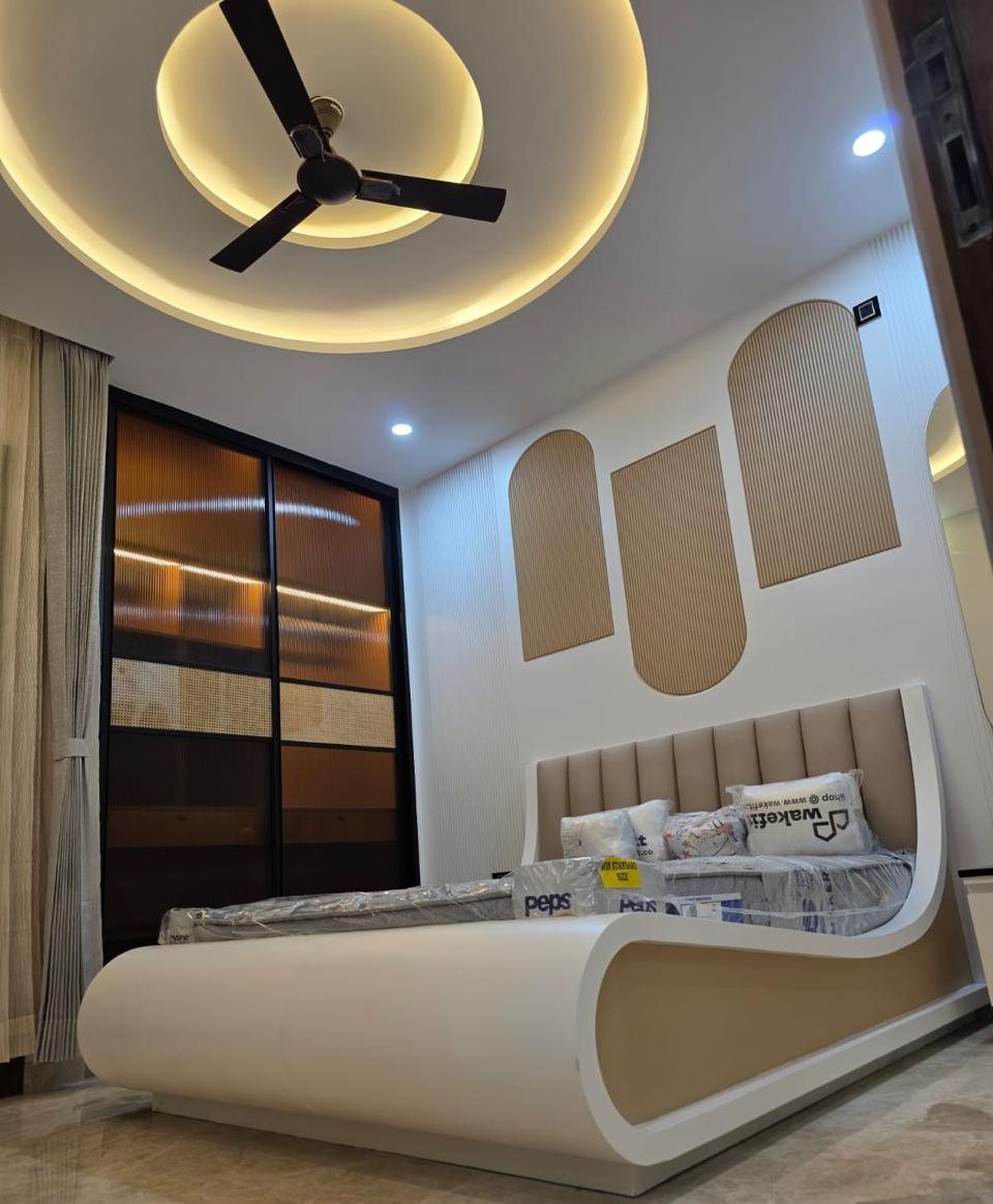 Bedroom with curved white bed and arched fluted panels